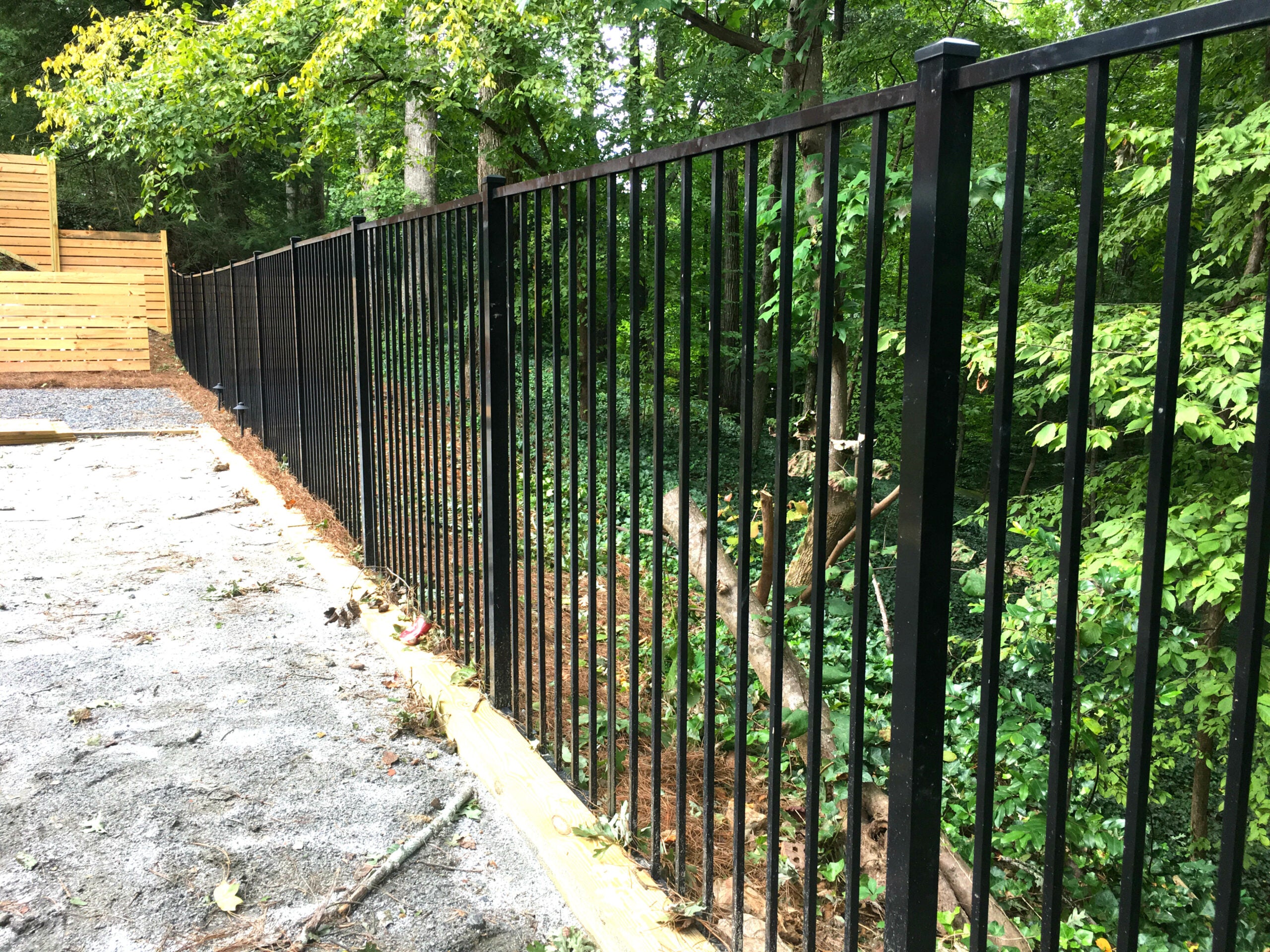 Black metal fence 2-rail aluminum fence for pool code with greenery in the background