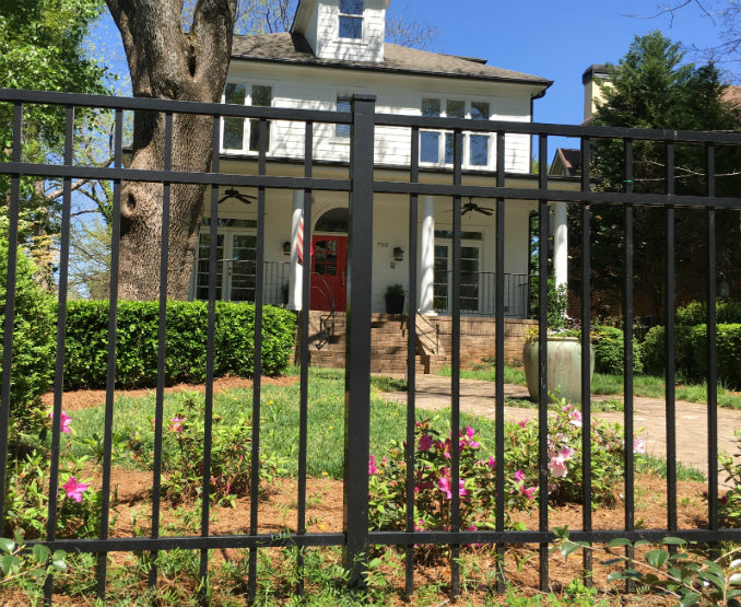Smooth top 3-rail aluminum fence with aluminum post in foreground