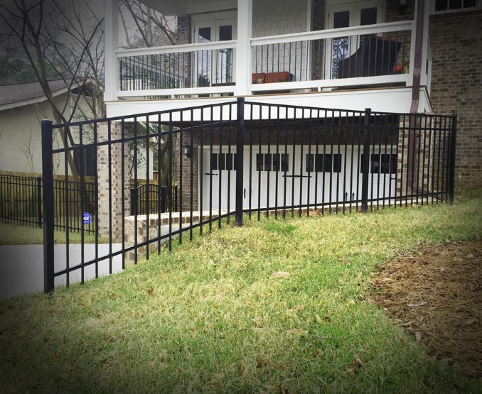 3-rail aluminum fence posts on a slope