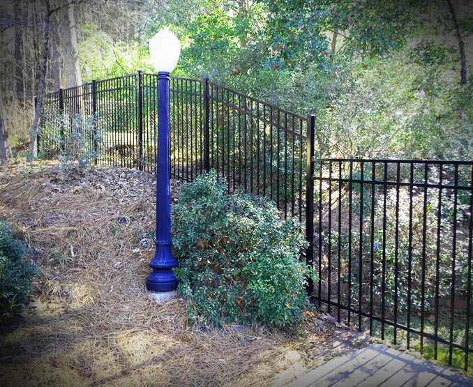 Smooth top 3-rail aluminum fence on a slope. Rackable aluminum fence panels.