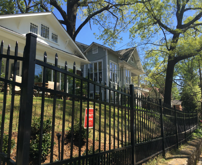 Black metal aluminum fence to secure pets in a front yard
