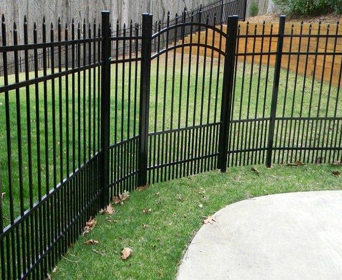 Black metal aluminum fence, added security for pets, with grass and a sidewalk in the foreground